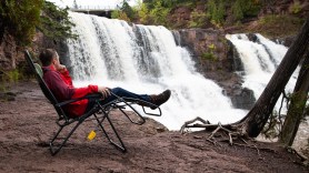 person relaxing in camping chair