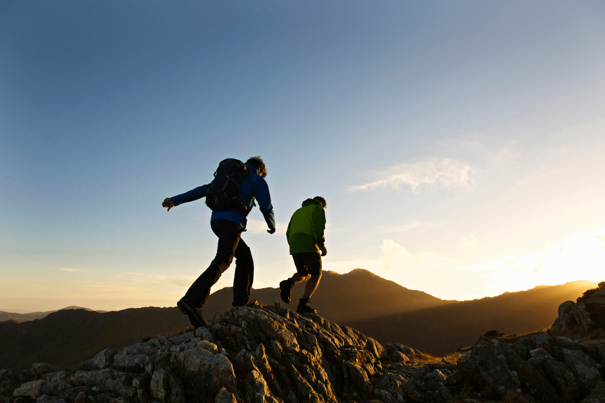 Hikers on a trail with a backpack cooler